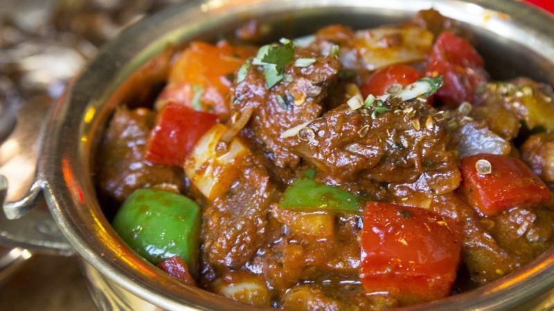 Lamb Kadhai · Cooked lamb braised in a masala of coarse ground spices with sautéed onions and bell peppers.
