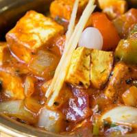 Kadai Panir · Glazed skillet paneer with onions and bell peppers herbs and spices.