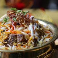 Goat Biryani (A Grand Indulgence) · Traditional home-style biryani rice with a touch of yogurt, spices, and herbs.