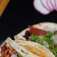 Al Pastor Tacos · 3 pastor tacos. One of the favorites with pineapple and delicious flavors.