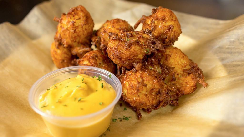 Pub Cheddar Tots · Made from scratch! Tater‑tots stuffed with sharp cheddar cheese. Served with our homemade cheese sauce.