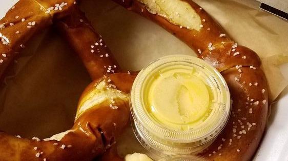 Jumbo Salt Crusted Pretzel · Jumbo soft pretzel glazed with butter and salt served with brown sugar sauce, honey mustard, and our homemade cheese sauce.