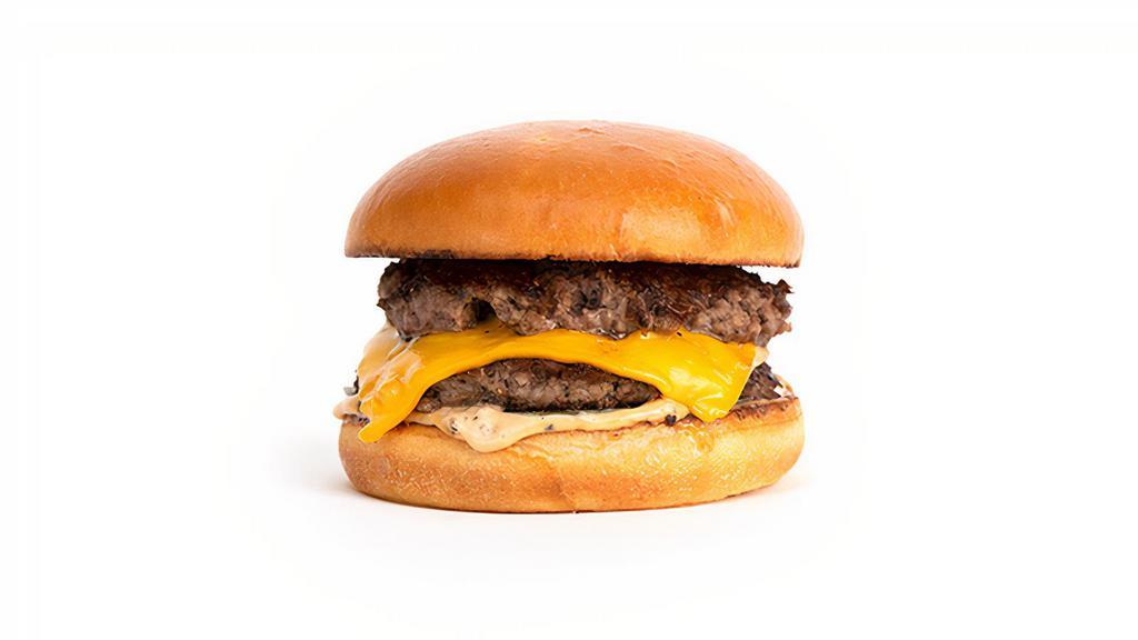 The Umami Burger · Smashed Double Patties, Dashi Onions, American Cheese, Pickle Chips, Umami Sauce on a Squishy Bun.