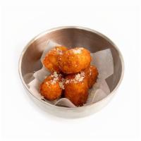 Cheesy Potato Tots · Hand breaded and deep fried potato tots filled with our signature three cheese blend, topped...