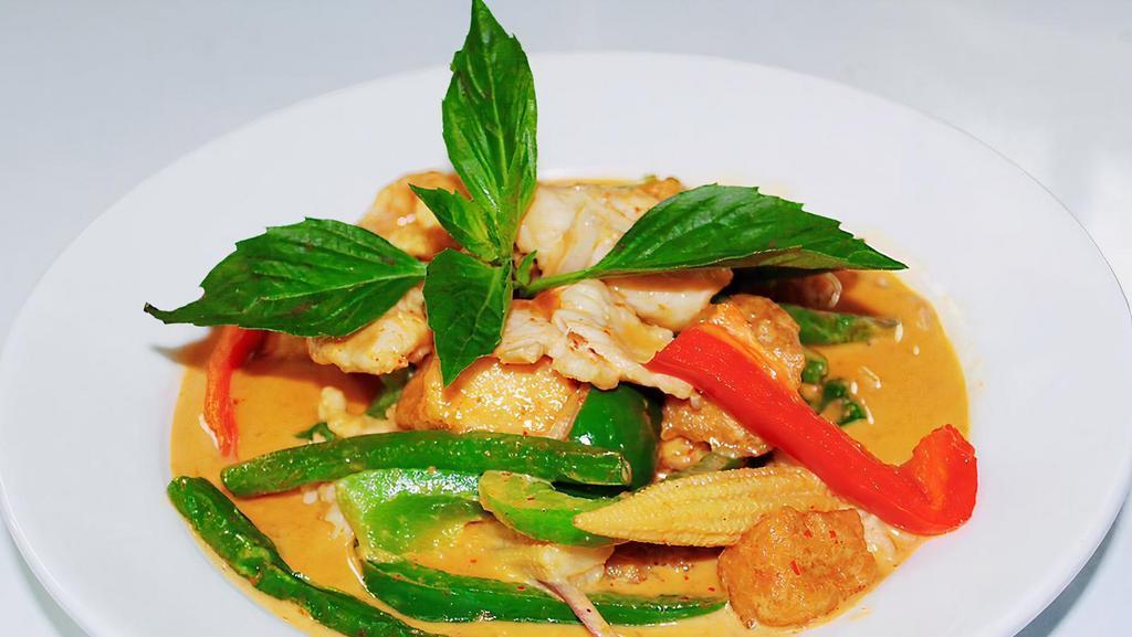 Red Curry Thai Entrée · Hot and spicy. Red onion, bell pepper, baby corn, string bean, fried tofu, and basil cooked with coconut milk.