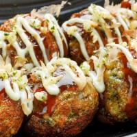 Wasabi Takoyaki · Wasabi mayo, sweet barbecue sauce, tempura crisp and bonito flakes.