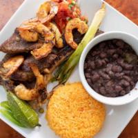 1) Venemex Special · Rib eye steak topped with six shrimps, pico De gallo, beans, roasted chile, and cambray onio...