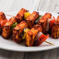 Paneer Shaslik · Chunks of cheese and pineapple skewered with onions, bell pepper, tomatoes and roasted in ou...