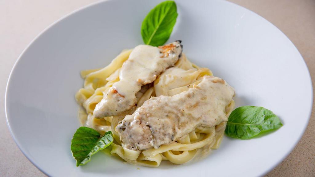 Fettuccine Alfredo · Served in a white buttery cream sauce & grated Parmigiana cheese.
