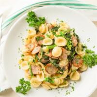 Orecchiette · Shell pasta served with sautéed broccoli rabe and sweet Italian sausage in a garlic and oil ...