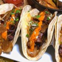 Steak Tacos · Marinated skirt steak, applewood bacon, Jack and cheddar cheese, Jack Daniels caramelized on...