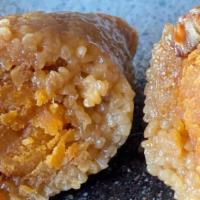 Zhongzi Sticky Rice Dumpling With Egg And Pork- 1 Piece · Zhongzi is a traditional Chinese rice dish made of glutinous rice stuffed with salty egg yol...