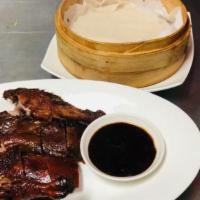 Peking Duck Half · Sliced duck serve with 4 homemade wraps with cucumbers, scallions and dipping sauce
