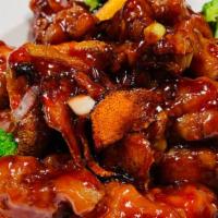 Orange Chicken · Crispy chicken  tossed in a sweet and spicy orange sauce. Served with choice of rice.