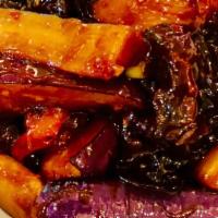 Eggplant In Garlic Sauce · Spicy. Vegetarian. Stir-fried eggplant in a garlic sauce. Served with choice of rice.