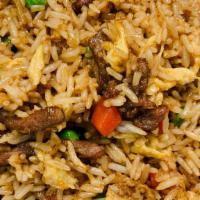 Fried Rice With Beef · Prepared steamed white rice, soy sauce, eggs, peas, carrots and green onions.