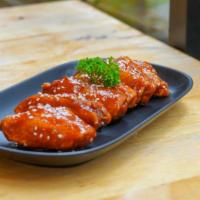 Spicy Chicken Wings · Spicy. Fresh-made chicken wings are smothered in a spicy marinade and served with a side of ...
