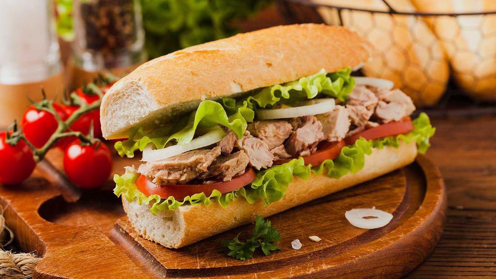 Tuna Sandwich · Hearty tuna salad with fresh and locally grown lettuce, onion, tomato, melted cheddar cheese, and mayo served on fresh-baked ciabatta bread with a side of choice.