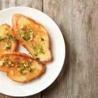 Garlic Bread · Fresh baked buttery garlic bread baked with grated Parmesan cheese, parsley, and a drizzle o...