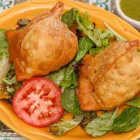 Samosas · Crispy triangle pastry stuffed with potatoes and peas or ground chicken and pea.