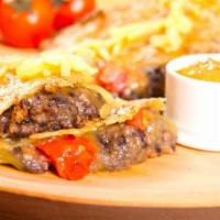 Philly Cheesesteak Quesadilla · Philly cheesesteak, mozzarella cheese, bell peppers, portabella mushroom, caramelized onion