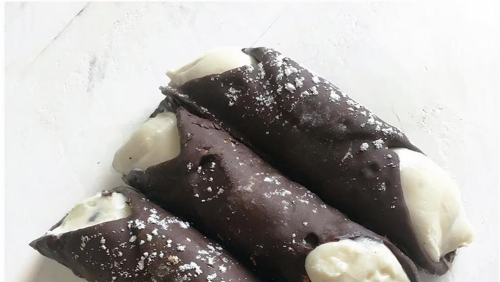 Chocolate Cannolo · Crispy hand dipped chocolate shell, sweet ricotta cream & chocolate chips

*Contains eggs, dairy, wheat, soy 
*Produced in a facility where nuts, milk, eggs, soy & wheat are present