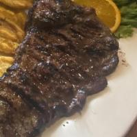 Carne Asada · Grilled steak served with rice, beans, and sweet plantains.