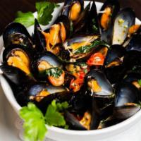 Mussels · Wide onion, light tomato broth with fresh herbs and scallions.