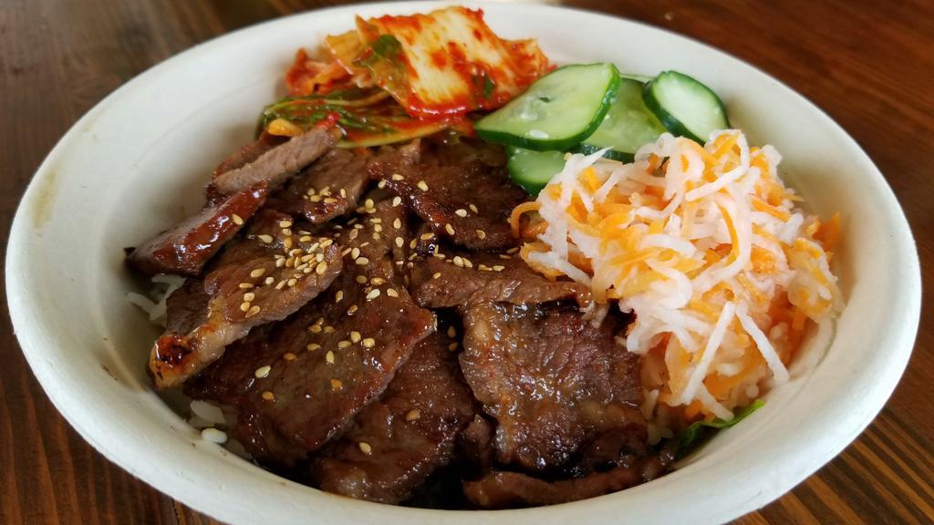 Galbi (Short Rib) Bowl · Grilled Soy-marinated Short Rib on a bed of lettuce and white rice, served with kimchi, daikon-carrot, and cucumber