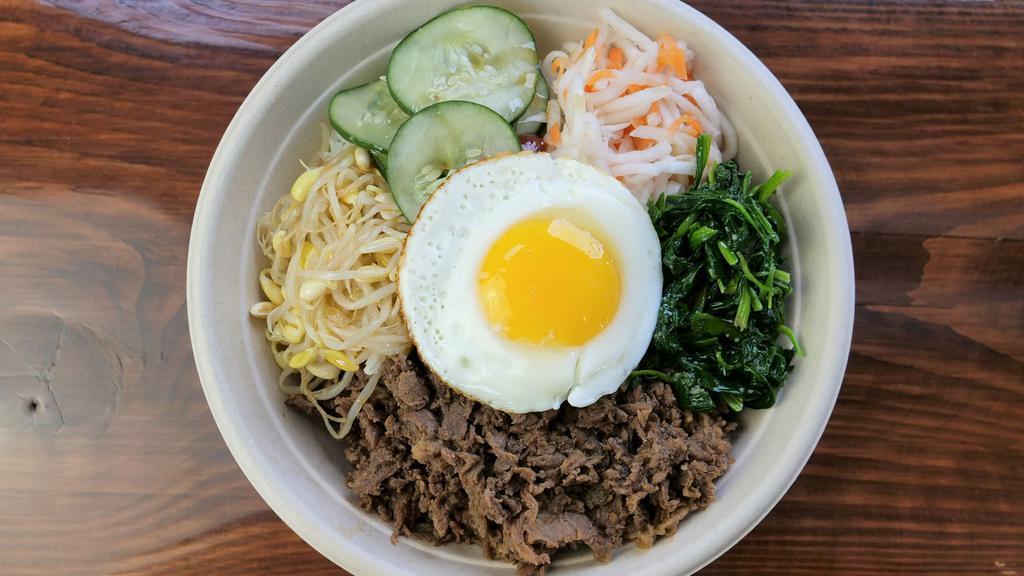 Bibimbap · The Korean Tradition at its best! 
a bowl of white rice with a protein of your choice, daikon carrots, cucumbers, spinach, bean sprouts, a fried egg and Gochujang sauce