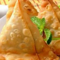 Samosa · Vegan. Pastry turnovers, spiced potatoes, and green peas. Served with a fresh mint and sweet...