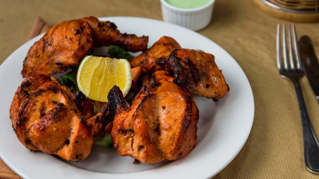 Grilled Tandoori Chicken · Young whole chicken marinated overnight and grilled in a traditional tandoor to perfection. Highly recommended.