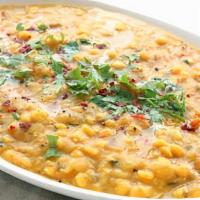 Daal Tadka · Vegan. Yellow lentils, garlic, cumin, mustard, curry leaf, and fried onion.