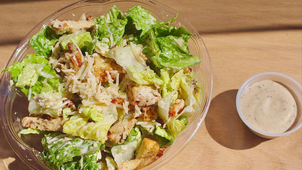 Grilled Chicken Caesar Salad · Romaine, grilled chicken, croutons, shaved parmesan and Caesar dressing.