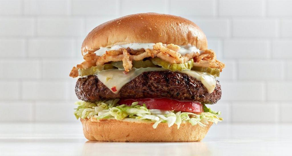 Ranchoburger* · Chile spiced, pepper jack cheese, pickles, fried onions, lettuce, tomato, roasted garlic ranch dressing, brioche bun