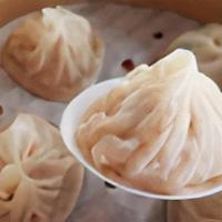Steamed Dumplings  (8 Dumplings) · 8 pieces of our well known soup dumplings stuffed with pork, served with ginger in red vineg...