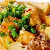 Ma-Po Tofu · world favorite, pieces of silken tofu marinated in brown sauce with green onion.