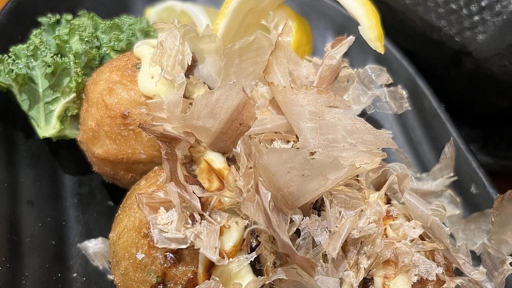 Takoyaki · 4 pieces. Ball-shaped Japanese snack made of wheat flour batter and diced octopus with special sauce.