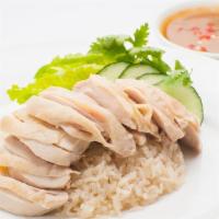 Steamed Dark Meat · (KHAO-MAN-GAI) . Traditional steamed boneless chicken thighs with ginger rice, lettuce, toma...