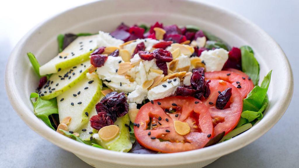 Goat Cheese Salad · Fresh mixed greens, tomatoes, fresh pears, dried cranberries, beets, black sesame seeds, roasted almond flakes, dressed in balsamic vinaigrette