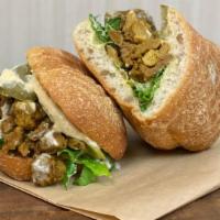 Med Vegan Shawarma · hummus, vegan shawarma, mediterranean pickles, chopped romain, topped with tahini sauce (opt...