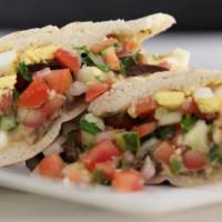 Classic Mediterranean Sandwich · Hummus, grilled eggplant, hard boiled egg, and Mediterranean chopped salad. (on Pita in photo)