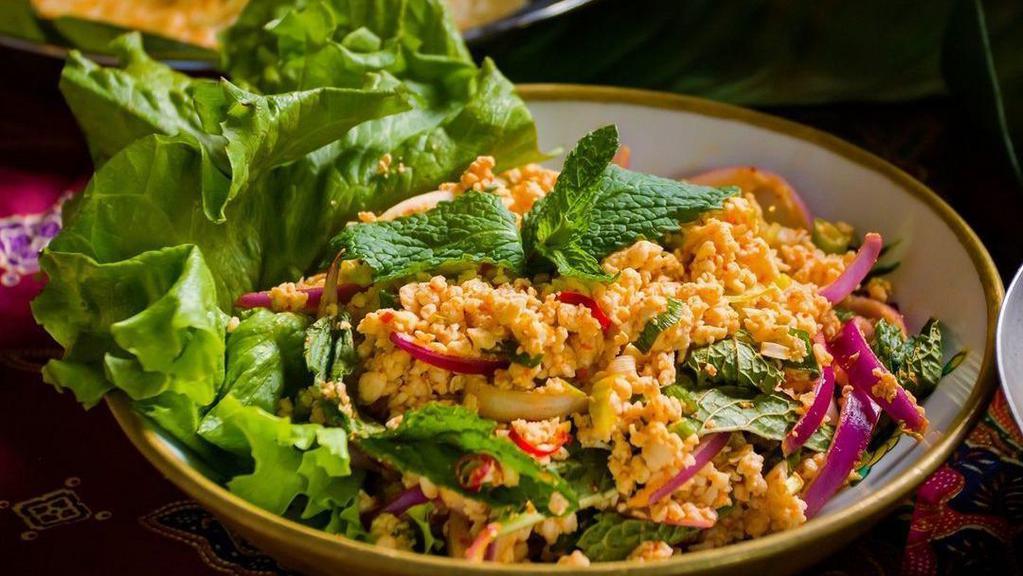 Isan-Style Larb Salad 🌾 🦐🌶️ · Gluten free. Spicy (can be altered and request for non-spicy option). Long beans, onion, mint leaf, lettuce, tomato, with your choice of chicken, shrimp, or seafood. Sauce contains shellfish