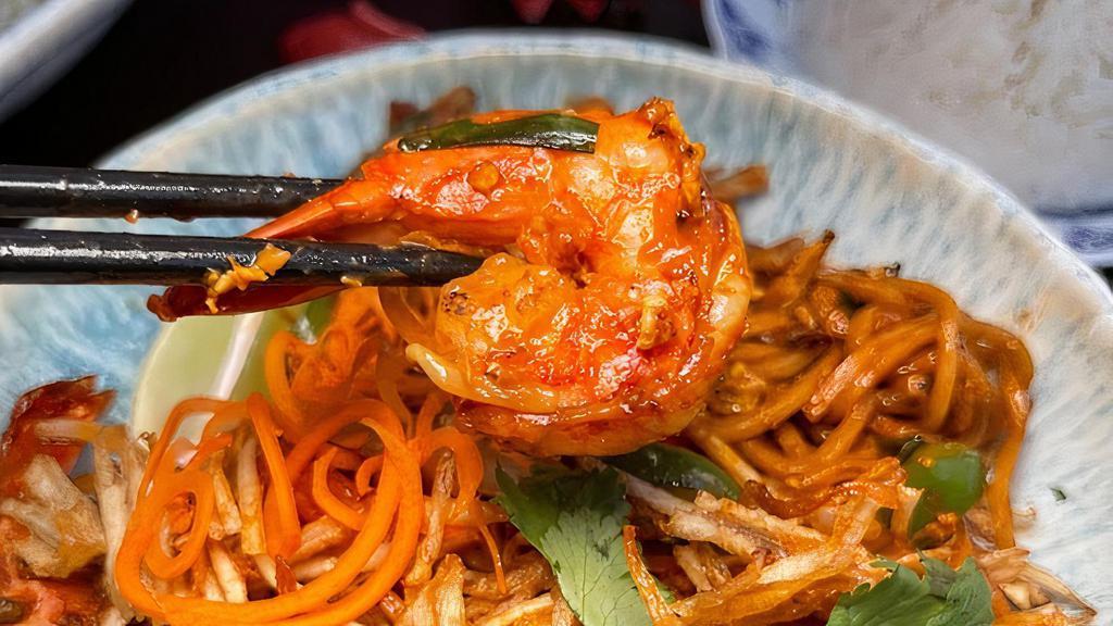 Mamak Mee Goreng 🌱💚🌾🌶️  · Not spicy. Indian Muslim egg noodle dish stir-fried in tomato sambal. Comes with your choice of one protein. Contains nuts, egg, tofu, bean sprouts, scallion, onion, tomato, shrimp fritter (can be removed by request), and egg noodle. Contains shellfish. Vegetarian option available.