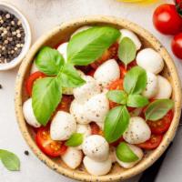 Fresh Mozzarella Salad · A bed of your choice of crisp lettuce topped with ripe tomatoes, roasted red peppers, black ...