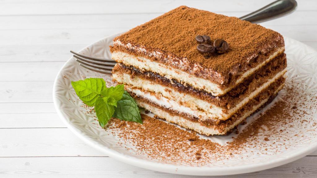 Tiramisu · Lady fingers delicately dipped in coffee and layered with a creamy mascarpone filling with a hint of cocoa.