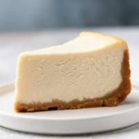Classic Cheesecake · Creamy, NY-style cheesecake with a sweet graham bottom crust. Topped with whipped cream.