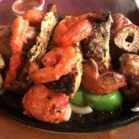 Tandoori Mixed Grill Platter · An assortment of tandoori chicken, chicken tikka, seekh kabab, chapli kabab and shrimp.
