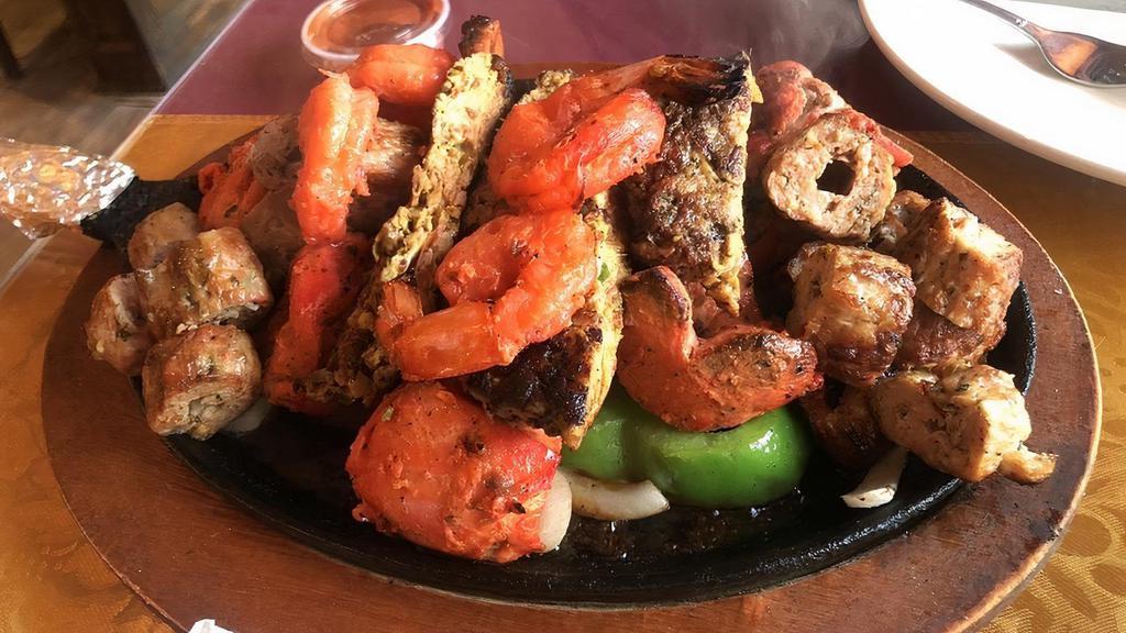 Tandoori Mixed Grill Platter · An assortment of tandoori chicken, chicken tikka, seekh kabab, chapli kabab and shrimp.