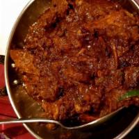 Rogan Ghost · Tender pieces of lamb or goat sautéed in thick onion gravy with garlic, tomatoes and fresh g...